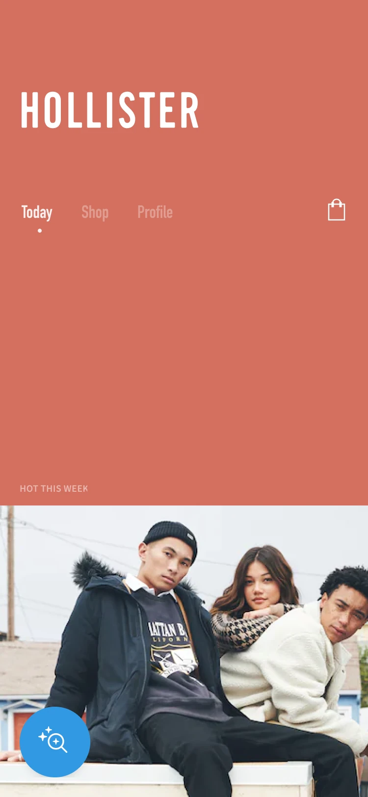 Hollister home screen with a coral background, condensed wordmark, shared navigation and a fashion campaign image.
