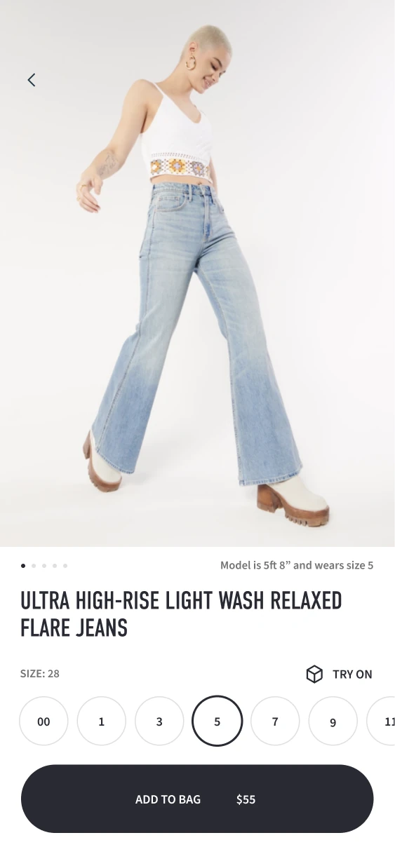 Relaxed flare-jeans product screen with a size selector, Try On and Add to Bag.