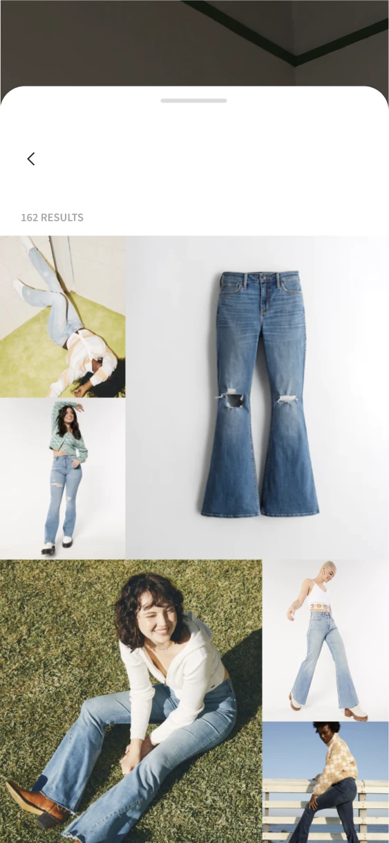 Search result grid mixing product-only and model photography of flared jeans.