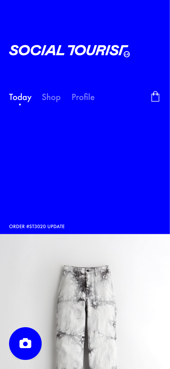 Social Tourist home screen with an order-update label and an image of previously purchased jeans.