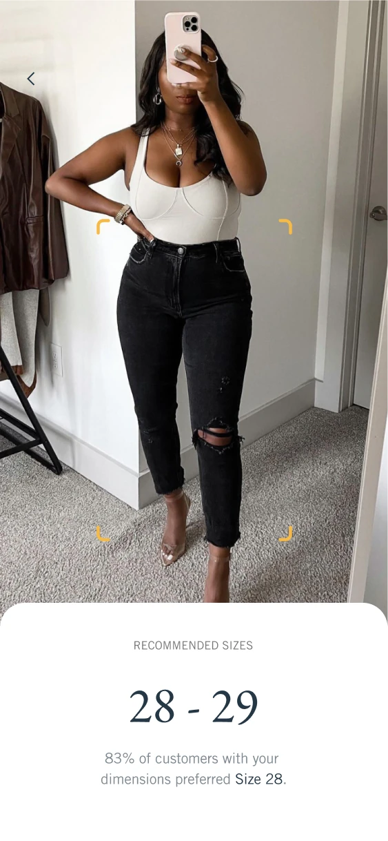 Virtual try-on screen showing jeans on a shopper and a bottom sheet recommending sizes 28 to 29.